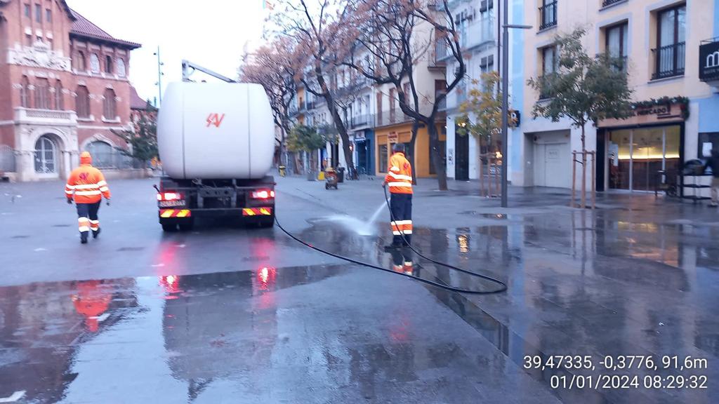 Servicios de limpieza baldeando el entorno de la Lonja y el Mercado Central tras la Nochevieja